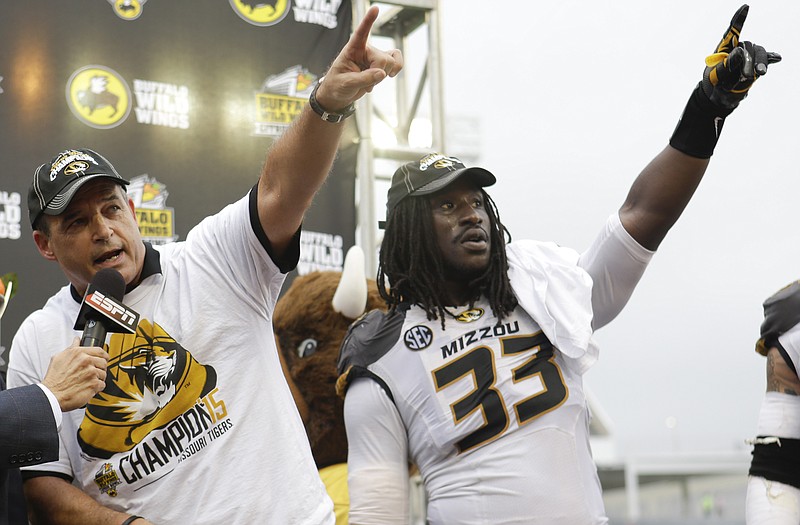 Missouri head coach Gary Pinkel and defensive end Markus Golden point to cheering Tiger fans Thursday after winning the Citrus Bowl against Minnesota in Orlando, Fla. Missouri was the only one of five Southeastern Conference teams to win its bowl game on New Year's Eve or New Year's Day.