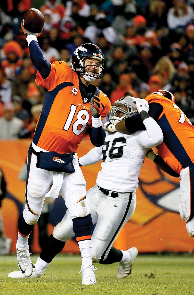 Broncos quarterback Peyton Manning throws a pass during the second half a game against the Raiders on Dec. 28 in Denver. 