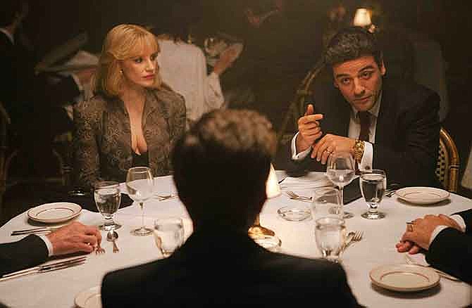 In this image released by courtesy of A24, Jessica Chastain, left, and Oscar Isaac appear in a scene from the film, "A Most Violent Year." 