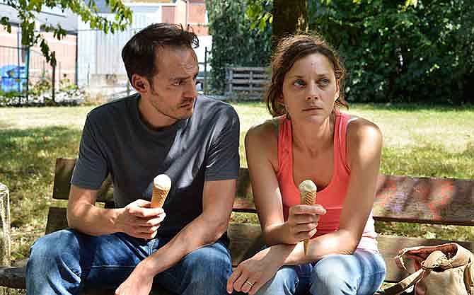 This photo released by Sundance Selects shows Marion Cotillard, right, as Sandra and Fabio Rongione, her husband Manu, in a scene from the film, "Two Days, One Night," written and directed by Belgian filmmakers, Jean-Pierre and Luc Dardenne.