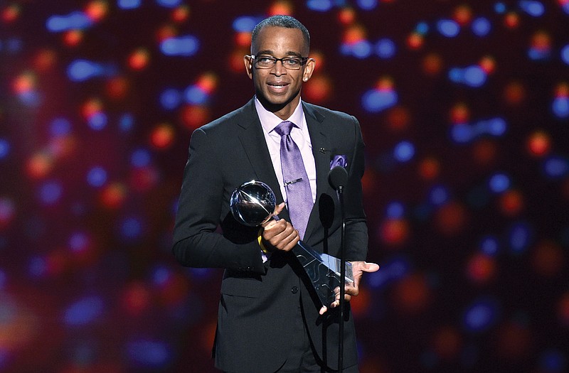 Sportscaster Stuart Scott accepts the Jimmy V award for perseverance in July at the ESPY Awards at the Nokia Theatre in Los Angeles. Scott died Sunday after a long fight with cancer. He was 49. 