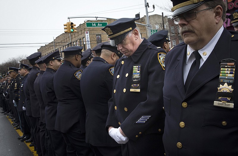 Some police officers turn their backs as Mayor Bill de Blasio speaks during the funeral of New York Police Department Officer Wenjian Liu on Sunday in the Brooklyn borough of New York. 
