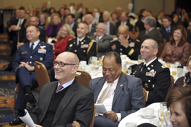 Rev. Doyle Sager laughs along with the crowd after hearing a brief story by featured speaker, Les Steckel, during the annual Governor's Prayer Breakfast Wednesday at the Capitol Plaza Hotel.