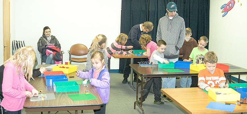 Supervised by parents and older siblings, children from kindergarten through third grade participate in the LEGO Junior Maker Program at the Moniteau County Library at Wood Place Tuesday.
