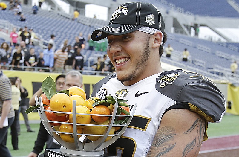 Missouri defensive end Shane Ray smiles while holding the trophy after last week's win against Minnesota at the Citrus Bowl in Orlando, Fla.