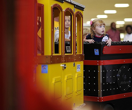 Elizabeth Dall, right, watches from a passenger car on the children's train at the Capital Mall.