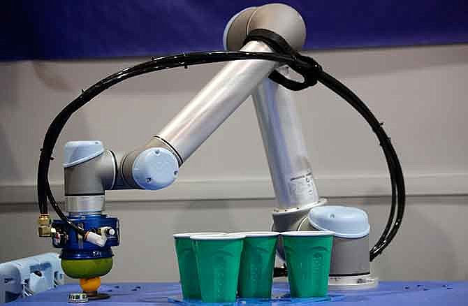 A robot plays beer pong at the Empire Robotics booth at the International CES, Thursday, Jan. 8, 2015, in Las Vegas. 