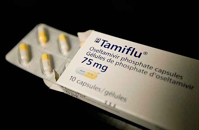 This April 30, 2009, file photo shows a box of Tamiflu in a Toronto health clinic. The Centers for Disease Control and Prevention on Friday, Jan. 9. 2015, sent a new alert to doctors, advising prompt use of Tamiflu and other antivirals for hospitalized flu patients and those at higher risk for complications like pneumonia.