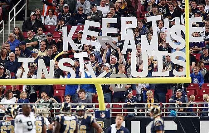 In this Nov. 30, 2014 photo, St. Louis Rams fans in the end zone spell out Keep The Rams In St Louis during an NFL football game against the Oakland Raiders at the Edward Jones Dome in St. Louis.