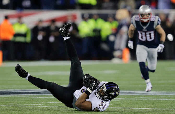 Baltimore Ravens inside linebacker Daryl Smith (51) intercepts a pass by New England Patriots quarterback Tom Brady (12) in front of New England Patriots wide receiver Danny Amendola (80) in the first half of an NFL divisional playoff football game Saturday, Jan. 10, 2015, in Foxborough, Mass.