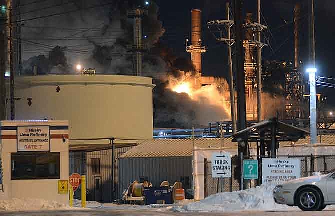 Heavy black smoke billows from Husky Lima Refinery after an explosion at the facility that shook Lima and the surrounding area early Saturday morning, Jan. 10, 2015, in Lima, Ohio. (AP Photo/The Lima News, Craig J. Orosz )