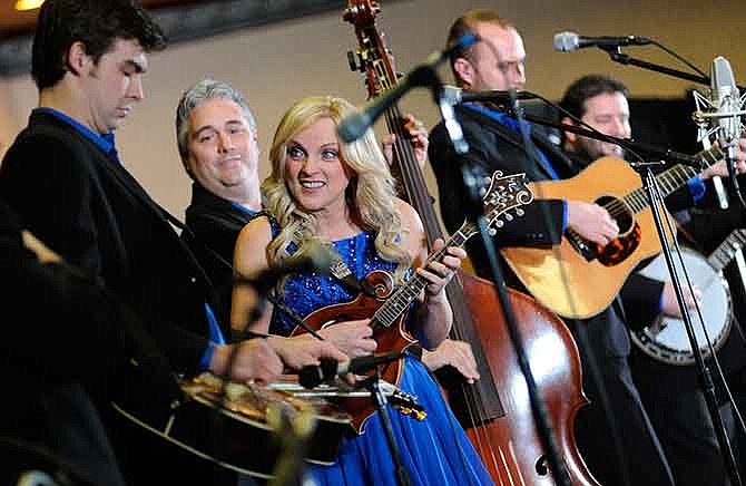 
Bluegrass superstar Rhonda Vincent watches The Rage dobro player Brent Burke as he shines in a solo called "Dobro Chimes" during the band's first show of the day during opening day of the 41st annual Society for the Preservation of Bluegrass Music of America (SPBGMA) Bluegrass Music Awards and 32nd annual Midwest Convention at the Capitol Plaza Hotel in Jefferson City on Friday.