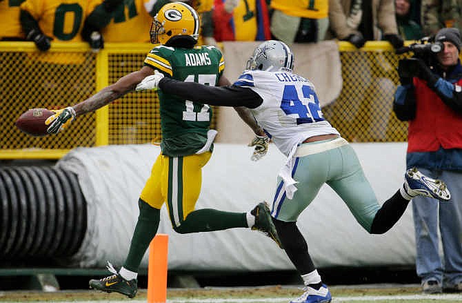 Green Bay Packers wide receiver Davante Adams (17) runs to the end zone for a touchdown against Dallas Cowboys strong safety Barry Church (42) during the second half of an NFL divisional playoff football game Sunday, Jan. 11, 2015, in Green Bay, Wis.