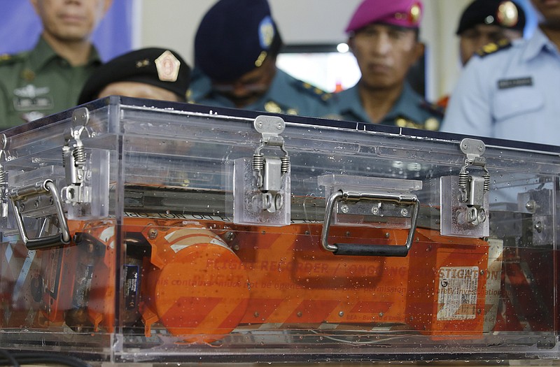 A black box of the ill-fated AirAsia Flight 8501 that crashed in the Java Sea, is briefly displayed at airport in Pangkalan Bun, Indonesia.