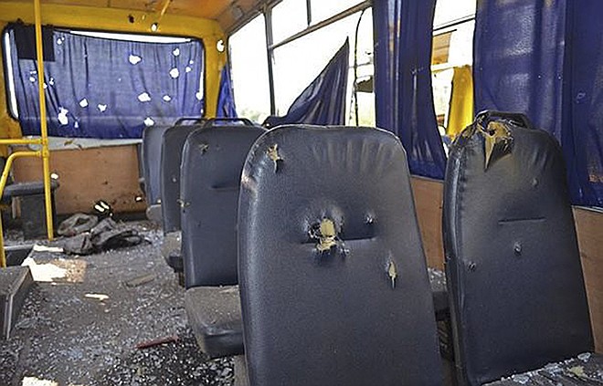 This photo shows the inside view of a bus destroyed by a rebel shell. The bus was hit at the checkpoint near Volnovakha in the Donetsk region of eastern Ukraine, Tuesday. At least 10 civilians were killed and a further 13 wounded as the bus was hit by a pro-Russian separatists' shell while passing through the checkpoint, local officials said.