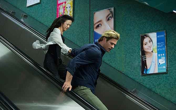 This photo provided by Universal Pictures shows, Tang Wei, left, as Chen Lien, and Chris Hemsworth, as Nicholas Hathaway in Legendary's film, "Blackhat," from director/producer Michael Mann. 