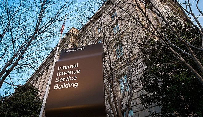 In this 2014 photo, the Internal Revenue Service Headquarters (IRS) building is seen in Washington. The IRS is cutting taxpayer services to historically low levels just as President Barack Obama's health law will make filing a federal tax return more complicated for millions of families.