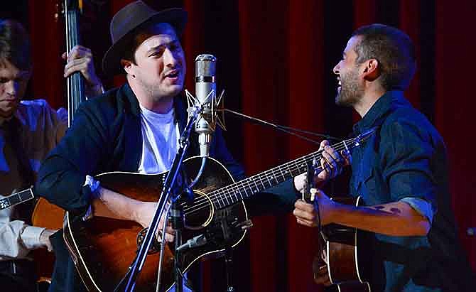 In this Sept. 29, 2013 file photo, musicians Marcus Mumford, left, and Oscar Isaac perform together during "Another Day, Another Time: Celebrating the Music of Inside Llewyn Davis" at The Town Hall in New York. Fans of the Coen brothers' amused, affectionate portrait of the 1960s Greenwich Village folk scene _ and of banjo-playing, guitar-plucking Americana in general _ will relish this recording of a 2013 New York concert celebrating the music of the movie "Inside Llewyn Davis."