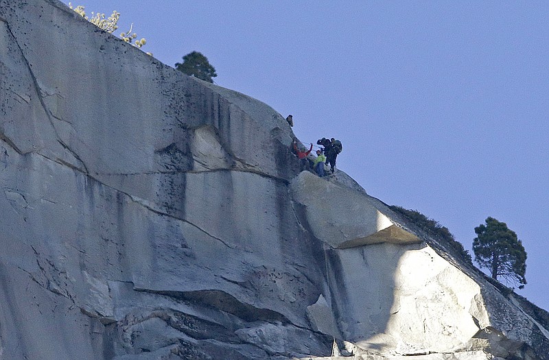 Kevin Jorgeson, bottom left, raises his arms beside Tommy Caldwell after both reached the summit of El Capitan.