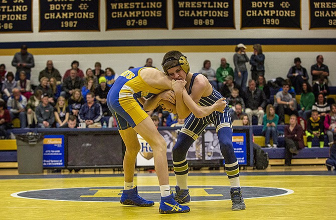 Helias' Zack Carr (right) locks up with Fatima's Clayton Haslag during their 113-pound match in Tuesday night's dual at Rackers Fieldhouse.