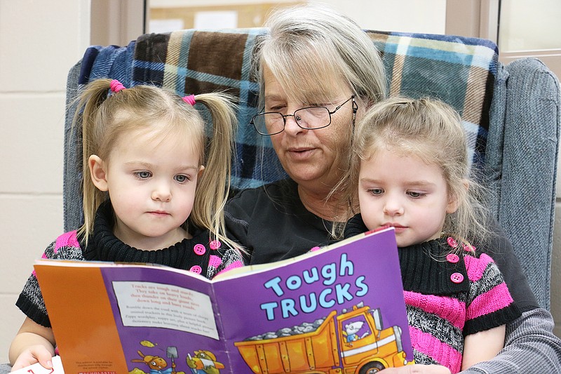 FILE: Janet Gerling reads to her two granddaughters, Isabella and Elizabeth Strube, at the South Callaway Parents as Teachers (PAT) Drop in and Play day. 