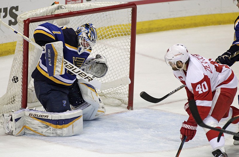 Detroit Red Wings' Henrik Zetterberg (40) watches a shot from teammate Pavel Datsyuk get past St. Louis Blues goalie Brian Elliott (1) for the win with 2.2 seconds left in overtime of an NHL hockey game, Thursday, Jan. 15, 2015, in St. Louis. The Red Wings won 3-2. 