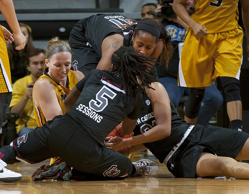 Missouri Michelle Hudyn, left, attempts to keep possession of the ball as South Carolina's Alaina Coates, top, Khadijah Sessions (5) and Aleighsa Welch try to steal it during the second half of an NCAA college basketball game Thursday, Jan. 15, 2015, in Columbia, Mo. South Carolina won the game 60-49.