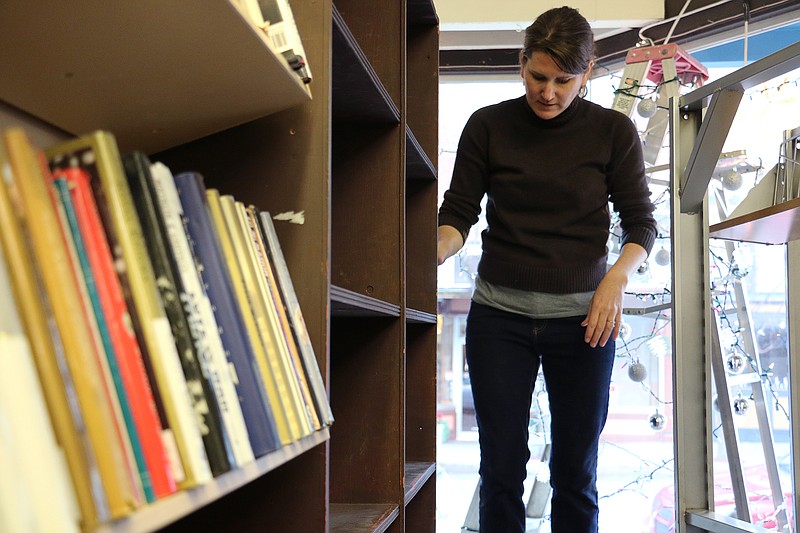 Well Read Books owner Danielle Warren moves bookshelves into place at the store's new location Thursday afternoon.The bookstore, which has been located at 519 Court Street for more than two years, moved across the street to 530 Court Street. It closed for a couple weeks while it moved; it reopens today. At the new location, the store will be open until 8 p.m. on Fridays instead of 6.