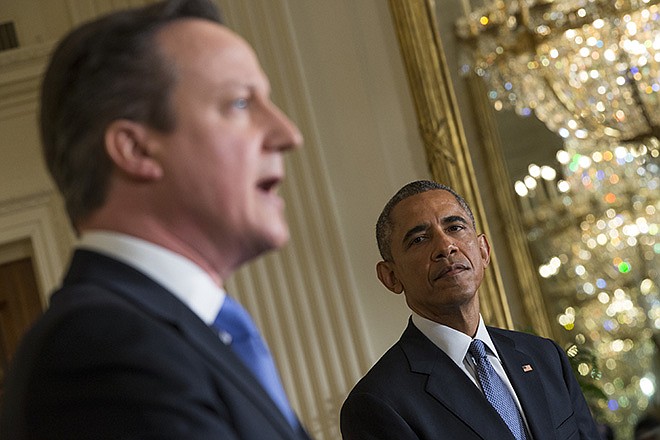 President Barack Obama listens as British Prime Minister David Cameron speaks Friday during their joint news conference in the East Room of the White House in Washington. In a show of trans-Atlantic unity, Obama and Cameron pledged a joint effort to fight domestic terrorism following deadly attacks in France.