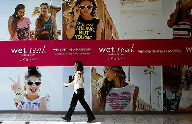 In this July 2, 2013, file photo, Shianne Penoli walks past the future location of Wet Seal at the Mount Shasta Mall in Redding, Calif. Wet Seal, a teen clothing retailer, has filed for Chapter 11 bankruptcy protection, the company announced Friday, Jan. 16, 2015. 