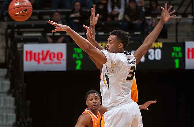 Missouri's Johnathan Williams III passes the ball as Tennessee's Robert Hubbs III watches during the second half of an NCAA college basketball game Saturday, Jan. 17, 2015, in Columbia, Mo. Tennessee won 59-51.