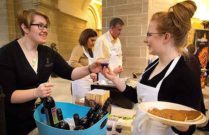 Christa Holtzclaw, marketing Specialist for the Missouri Wine and Grape Board, serves Missouri grape juice at a breakfast event in the state Capitol.