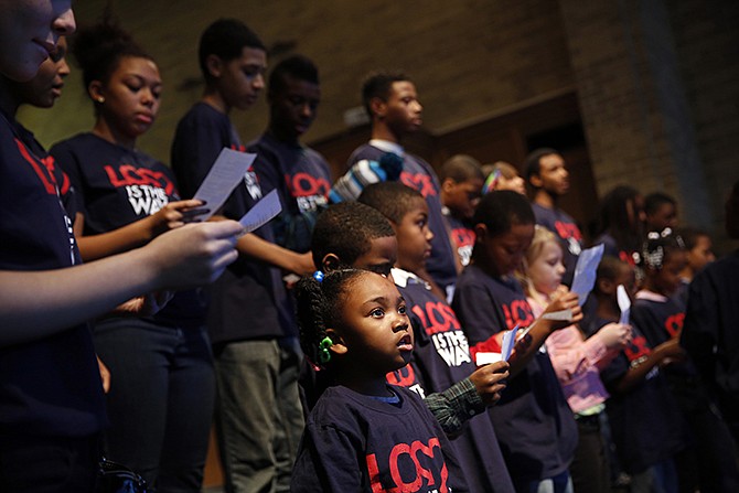 Children sing during a church service at Wellspring Church Sunday in Ferguson. Several members of the Congressional Black Caucus spoke during the service about Martin Luther King Jr,. a day before a federal holiday honoring the civil rights leader, as well as their desire to reform police procedures after the death of Michael Brown in Ferguson and other fatal police shootings nationwide. 