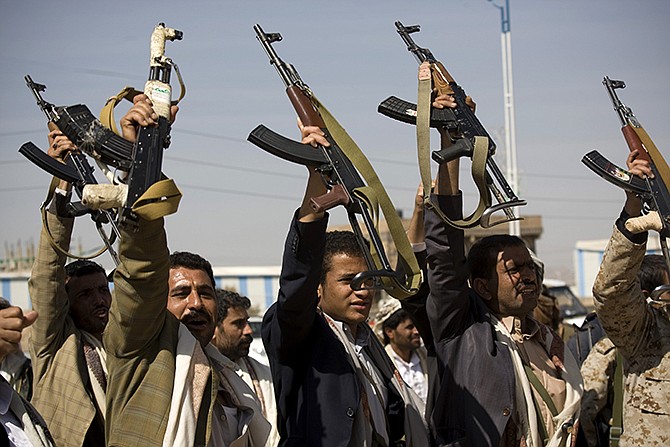 Houthi Shiite Yemeni raise their weapons during clashes near the presidential palace in Sanaa, Yemen, Monday. Rebel Shiite Houthis battled soldiers near Yemen's presidential palace and elsewhere across the capital, despite a claim of a cease-fire being reached to halt the violence, witnesses and officials said. 