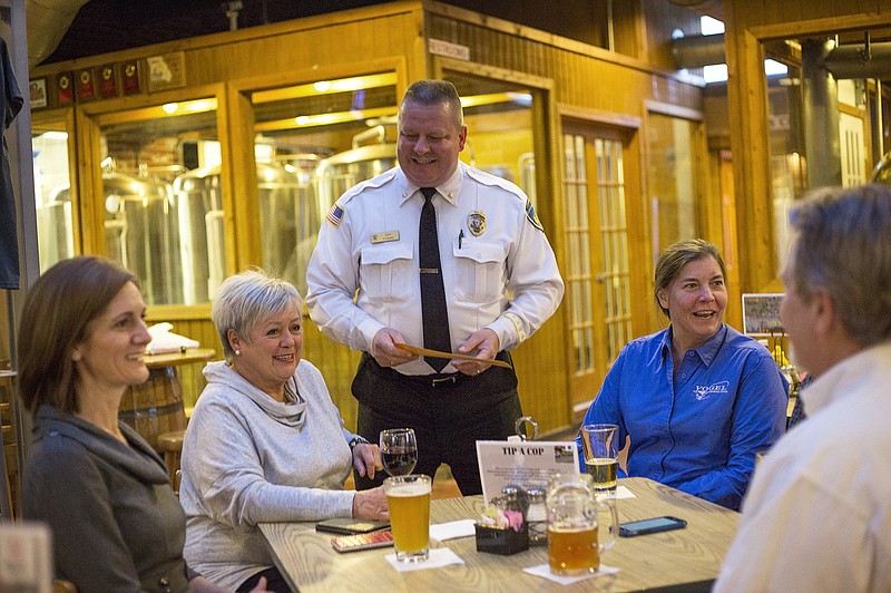 Timothy Goebel, chief of custody at Jefferson City Correctional Center, talks to diners at Prison Brews Tuesday evening during the prison's Tip a Cop event. At the fundraiser, t-shirts are sold and donations are accepted in the form of tips as members of the JCCC staff serve patrons in the restaurant. Proceeds will go to Special Olumpics of Missouri.