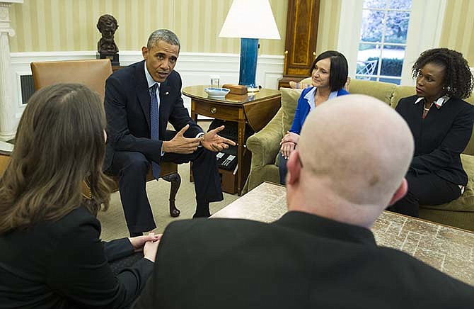 President Barack Obama meets with four of the letter writers who will join the First Lady and Dr. Jill Biden at the State of the Union address, Tuesday, Jan. 20, 2015, in the Oval Office of the White House in Washington. Clockwise, foreground, from left are, Victor Fugate of Kansas City, Mo., Rebekah Erler of Minneapolis, the president, Carolyn Reed of Denver and Katrice Mubiru of Woodland Hills, Calif. 