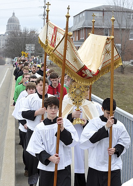 Acolytes from local Catholic schools carry the baldacchino covering the Rev. Colin Franklin and the Holy Eucharist following a prayer service at St. Peter Church. Participants in this year's Eucharistic Prayer March made their way across town to St. Joseph Cathedral where they boarded buses to go to the March for Life in Washington.