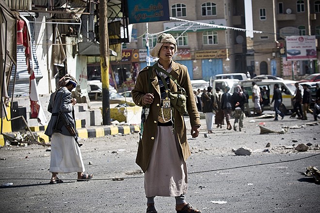 Houthi Shiite Yemeni gather while guarding a street leading to the presidential palace Tuesday in Sanaa, Yemen. Yemen's U.S.-backed leadership came under serious threat Monday as government troops clashed with Shiite rebels near the presidential palace and a key military base in what one official called "a step toward a coup."