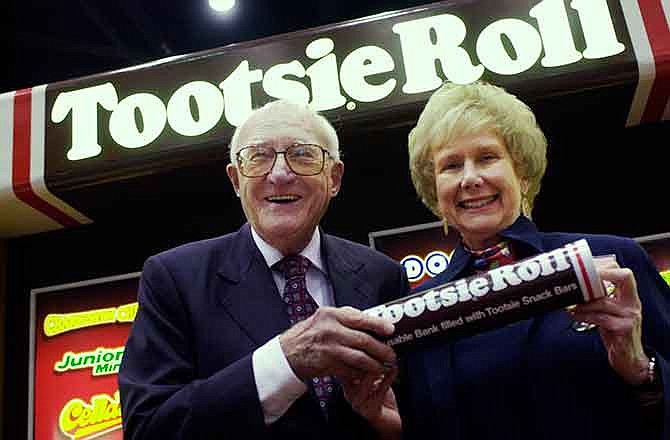 In this May 14, 2003 photo, Melvin Gordon, CEO of Tootsie Roll Industries, and his wife, Ellen, pose for a photo at the Candy Expo at Chicago's McCormick Place. A company spokesperson said Melvin Gordon died Tuesday, Jan. 20, 2015, in Boston after a brief illness. He was 95. Gordon ran the Chicago-based company for 53 years. It makes 64 million Tootsie Rolls a day and other favorites including Junior Mints, Charleston Chews and Tootsie Pops. (AP Photo/Sun-Times Media)