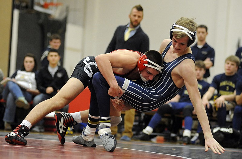 Jefferson City's Jacob Brune drives Helias' Cole Hazelhorst the the mat early in their 145-pound matchup during Wednesday night's dual at Fleming Fieldhouse.