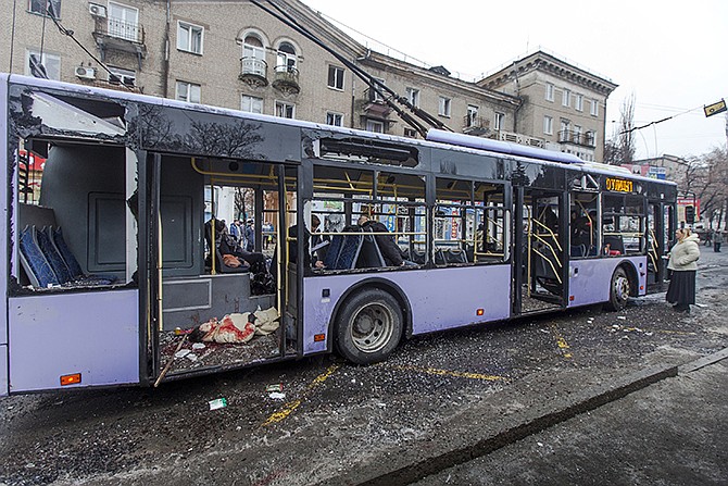 Passengers killed when a trolley bus was damaged by a mortar shell are seen inside a bus in Donetsk, eastern Ukraine on Thursday. A new peace initiative for Ukraine began taking shape as mortar shells rained down on the center of the main rebel-held city in the east, killing at least 13 people at a bus stop. The civilian death toll has been mounting steadily in the conflict between Ukrainian troops and Russian-backed separatists that the United Nations says has killed more than 4,700 people since April.