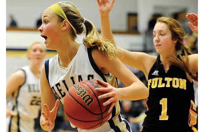 Luci Francka of Helias drives to the basket around Fulton's Sloane Totta during Friday night's game at Rackers Fieldhouse in Jefferson City.