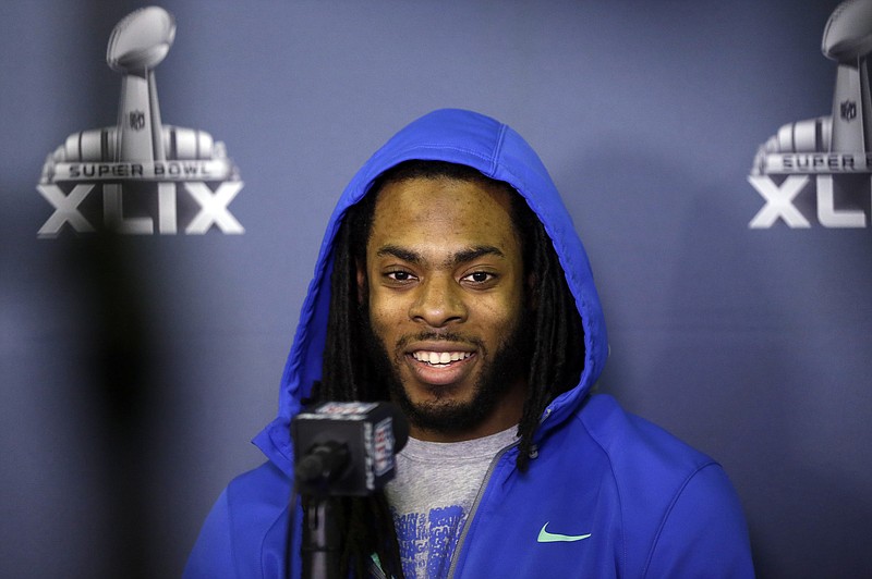 Richard Sherman of the Seahawks answers a question at a news conference Sunday in Phoenix.