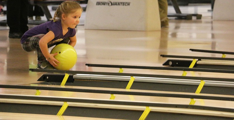 St. Peter School pre-K student Marley pushes her bowling ball down the lane at the Fulton Bowling Center Monday morning.