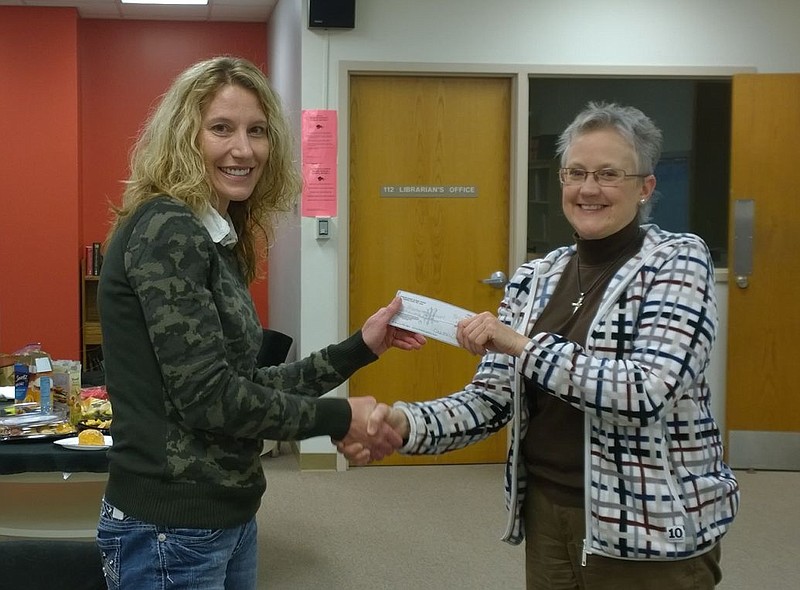 Prairie Home R-V Board of Education accepts a $2000 donation from Prairie Home Alumni Association president Nancy Lacy Kixmiller.