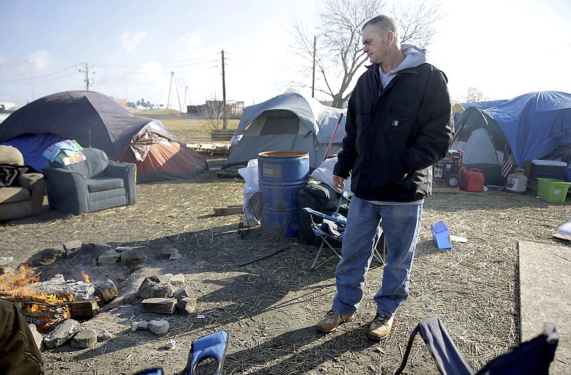 Chad Bergman stands in a large homeless encampment where he lives and is known as the "mayor" Tuesday near downtown St. Louis. The city plans to tear down the camp down due to health and safety concerns, but Human Services director Eddie Roth says officials will work with those living in tents to help them find better alternatives.
