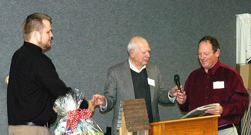 Gail Hughes, center, names VisionHealth Eyecare as the 2014 Chamber of Commerce Business of the Year. Dr. Don Vanderfeltz, right, began the business in California in 1979. Dr. Nathan Dieckow, right, is his associate in the business.