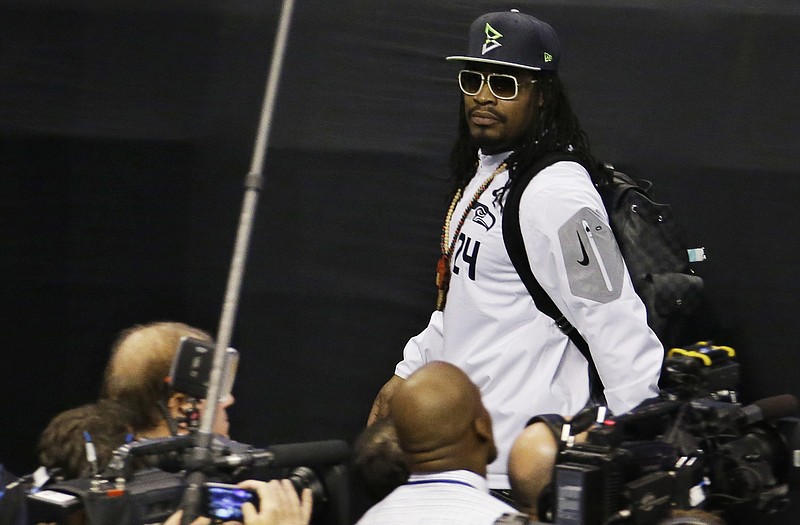 Seahawks running back Marshawn Lynch leaves Super Bowl Media Day on Tuesday in Phoenix.