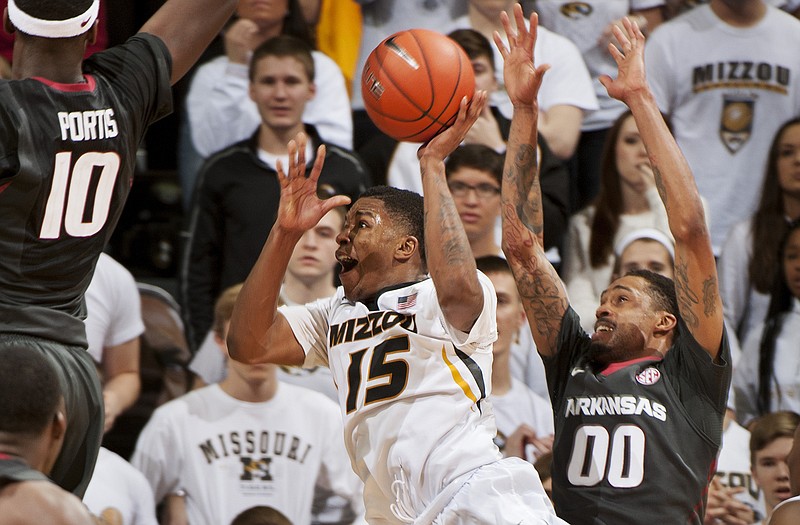 Wes Clark of Missouri is fouled by Arkansas' Rashad Madden as he shoots in the final seconds of Saturday afternoon's game at Mizzou Arena. Clark missed the two ensuing free throws and Arkansas won the game 61-60.