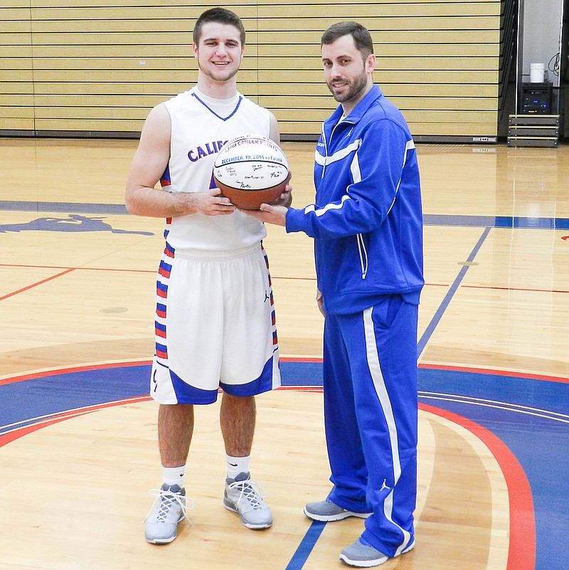 California senior Jaden Barr received a ceremonial game ball from boys basketball head coach Blair Scanlon for surpassing 1,000 career points. Barr, who accomplished the milestone at the Linn Invitational in December, was honored before the Osage game on Tuesday, Jan. 20.